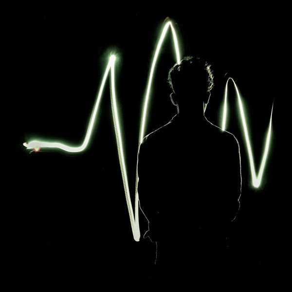 Abstract silhouette of a human body with glowing energy lines.
